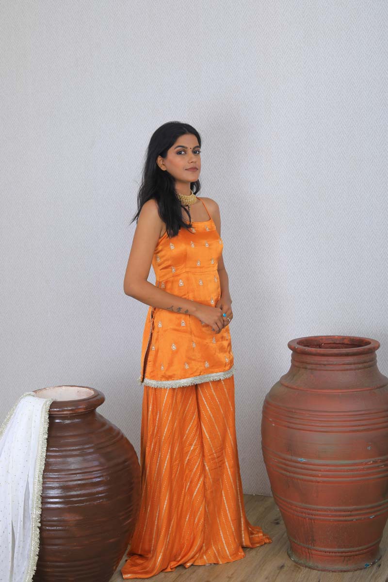 Girl wearing a Traditional Orange Palazzo Set with embroidery and luxurious silk fabric