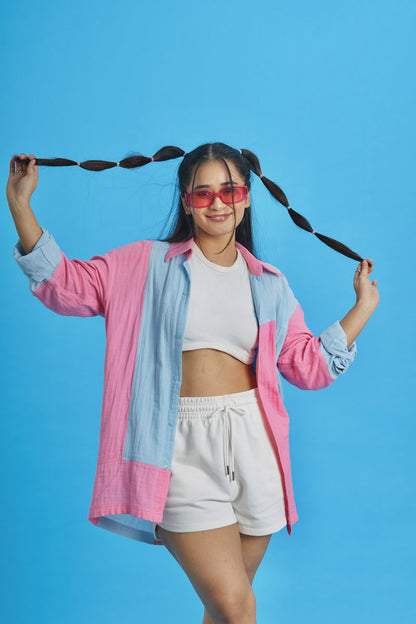 Girl wearing a loungewear patchwork shirt with pink and blue fabric patches 