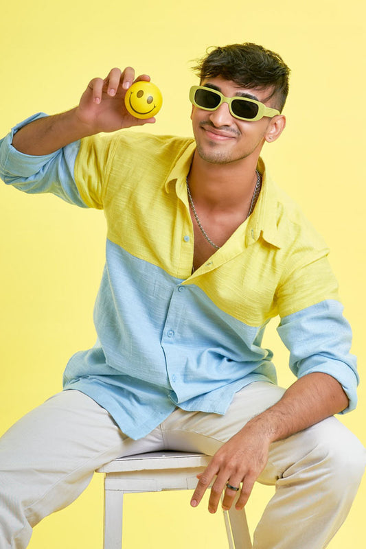 Guy wearing a full loungewear shirt with yellow and blue patchwork