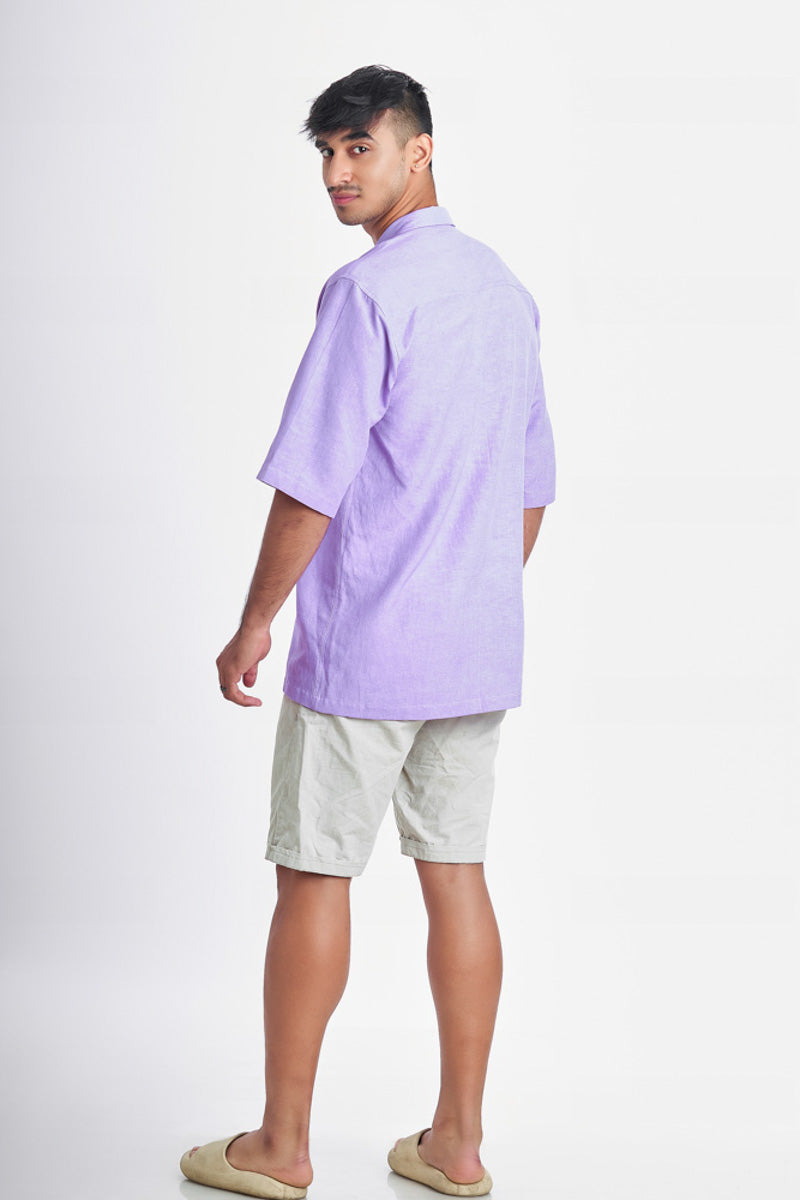 Person wearing an oversized lavender shirt facing the back